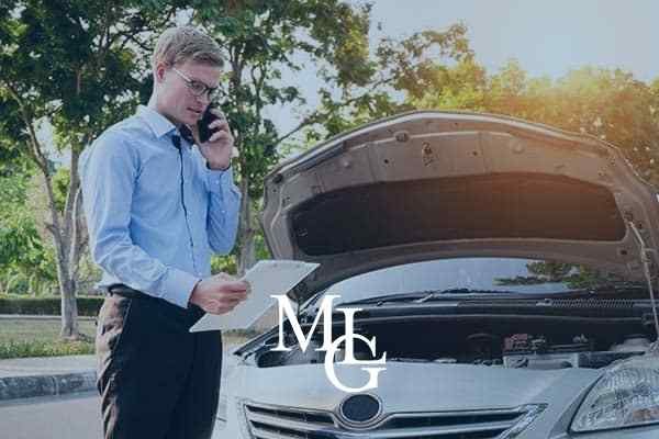 insurance adjustor looking at wrecked car