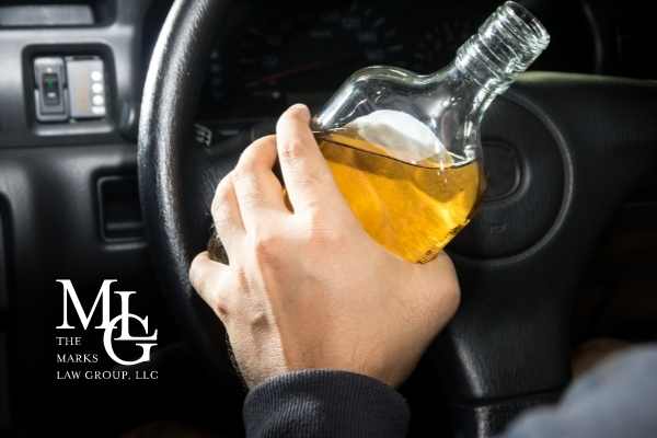 a photo of a man drinking while driving