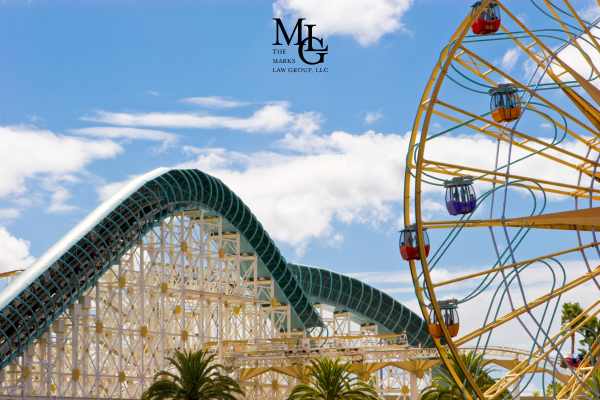 a roller coaster and ferris wheel at an amusement park