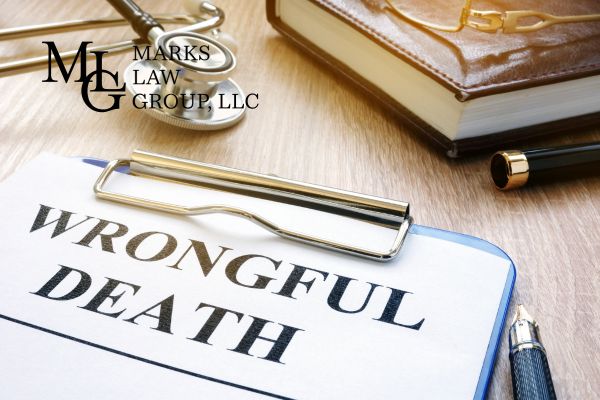 a wrongful death claim on a desk next to a book and a stethoscope
