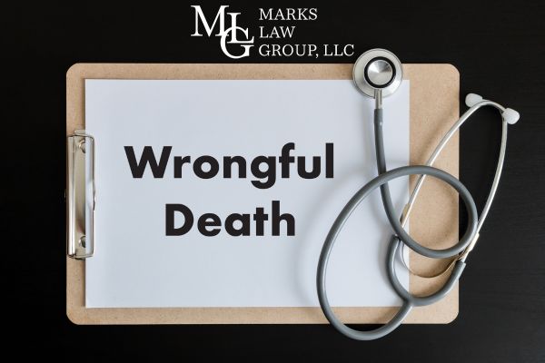 wrongful death written on a clipboard next to a stethoscope