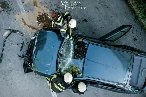 firefighters tending to a car after an accident