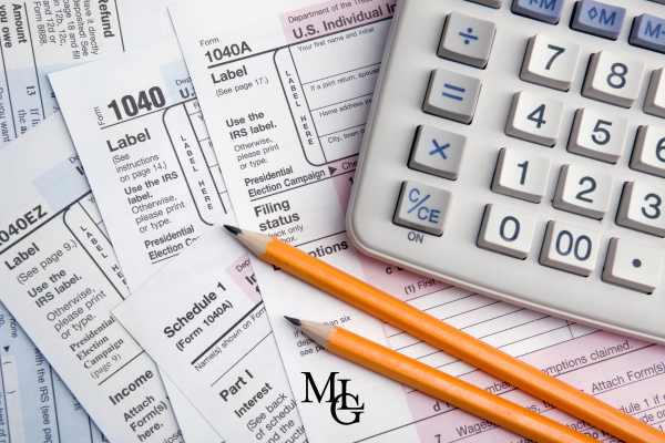 tax forms, and a calculator on a table